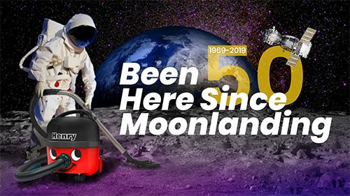 an astronaunt on the moon swiping the surface with a henry vacuum cleaner